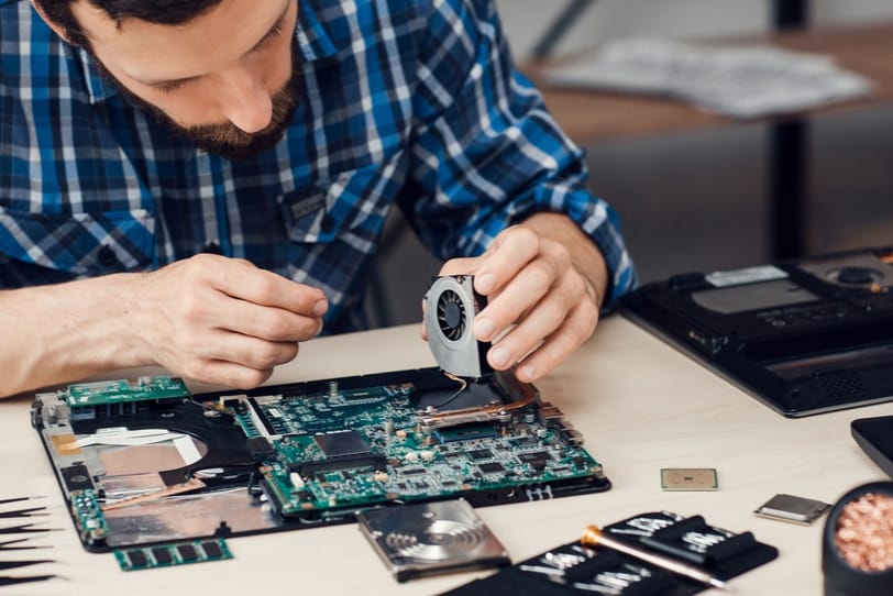 Data recovery technician working on a Mac hard drive in a professional setting